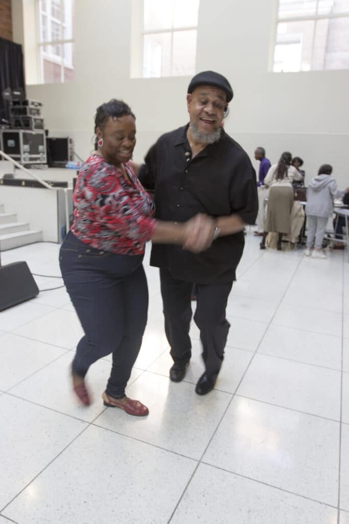 A man and woman dancing in a room.