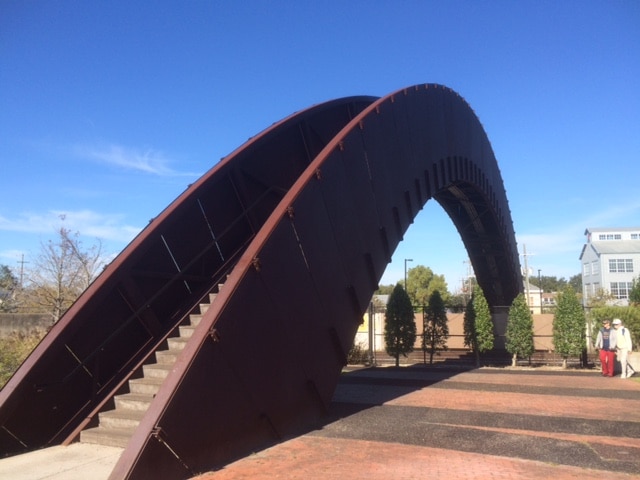 A large metal arch with stairs leading up to it.