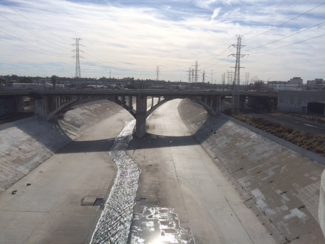 An image of a waterway with a bridge over it.