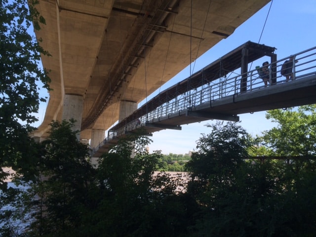 A bridge over a river with people walking on it.