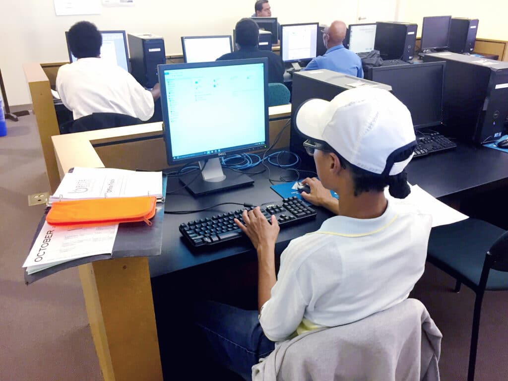 A man sitting at a desk using a computer at the Skyland Workforce Center.