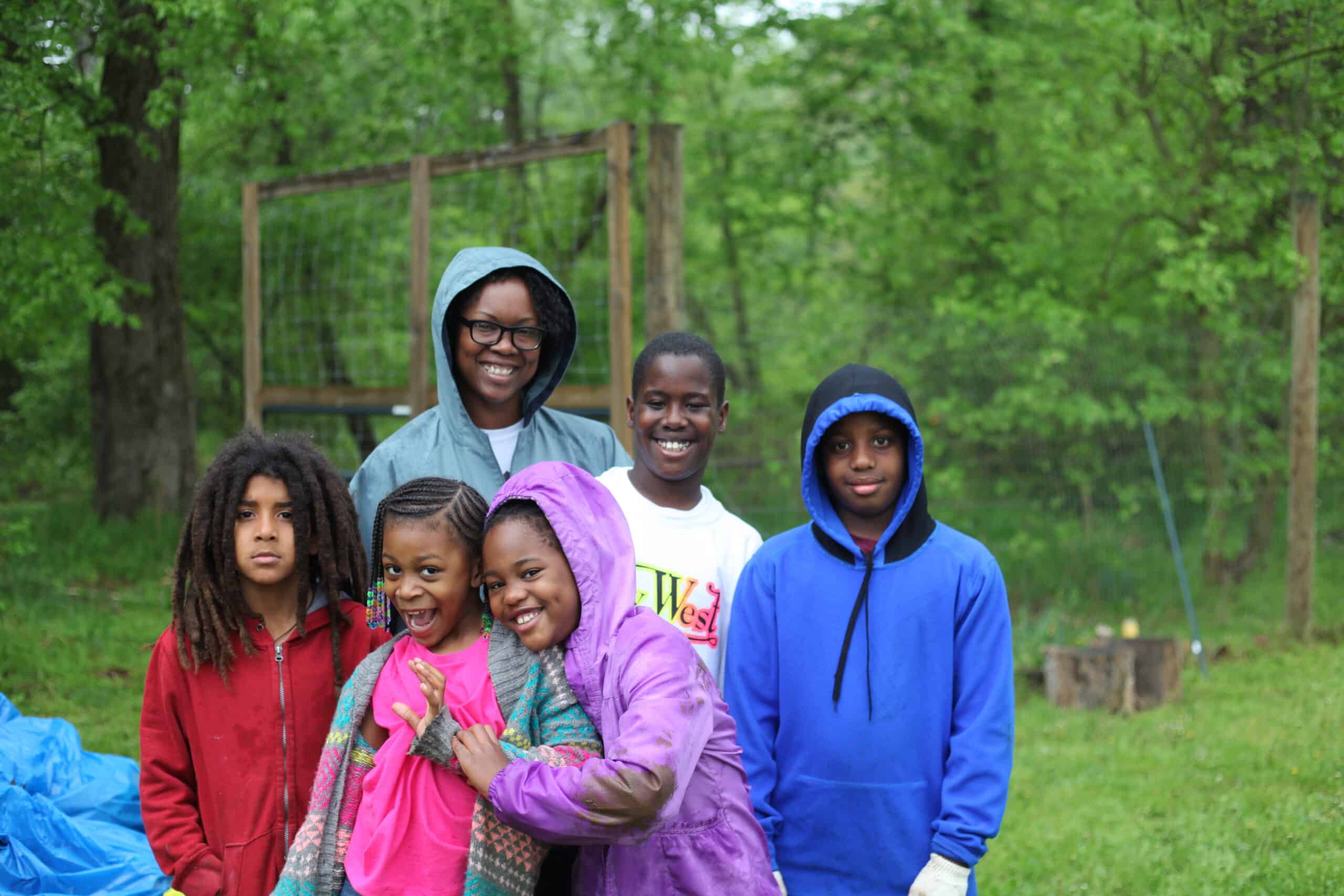 Cultivating urban farms for community growth, a group of children posing for a photo in Bridge Park.