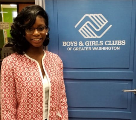 A woman standing in front of the boys and girls club of greater washington.