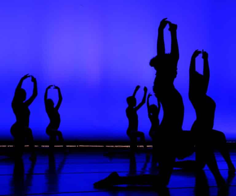 Silhouette of a group of dancers, promoting arts & community engagement.